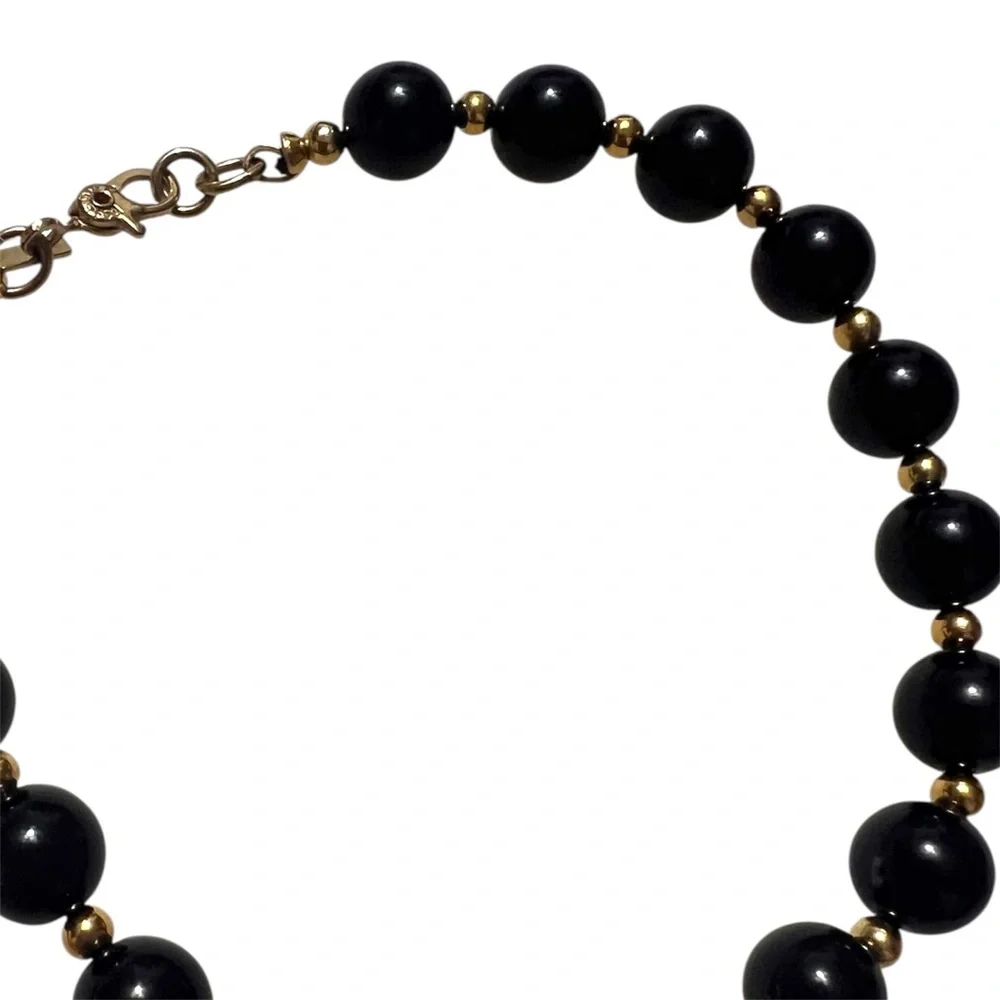 Vintage Monet signed black bead and gold tone spacers bracelet. 8”
